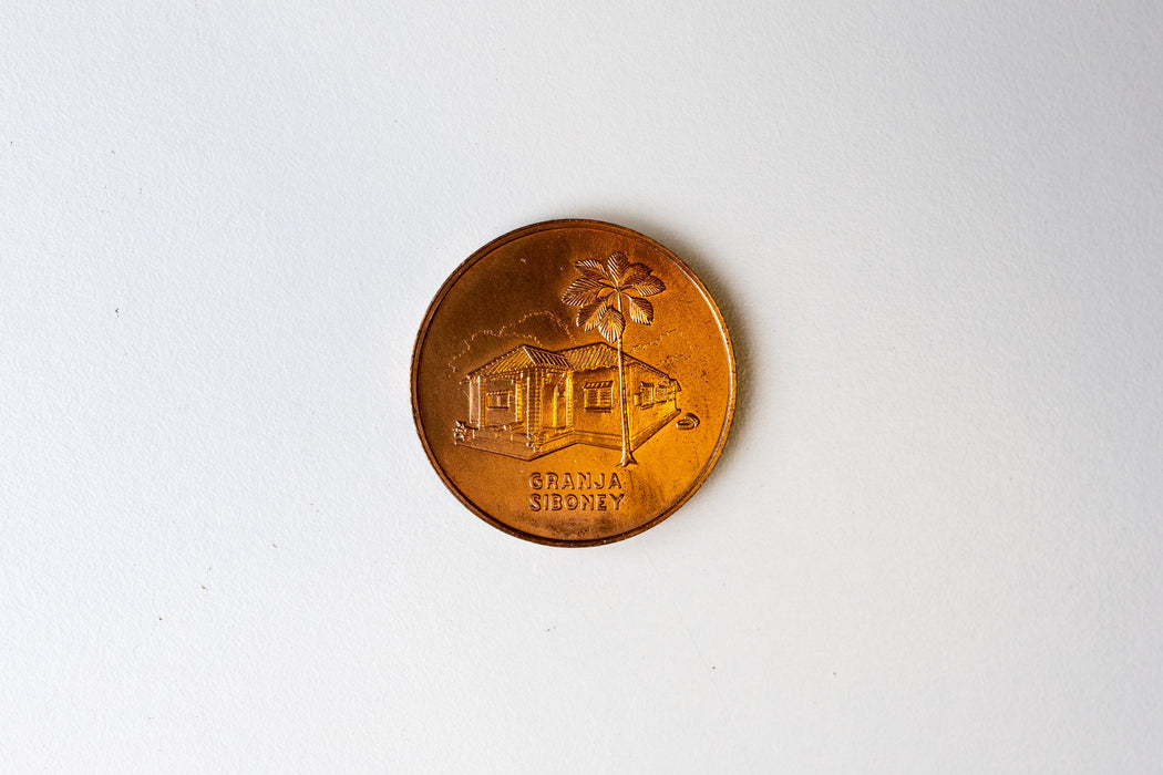Two rare Cuban coins, one likely signed by Fidel Castro