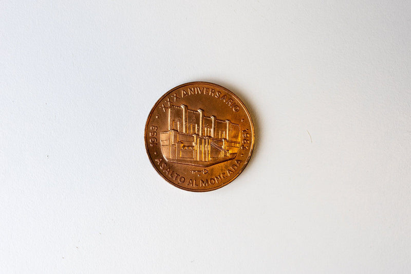Two rare Cuban coins, one likely signed by Fidel Castro