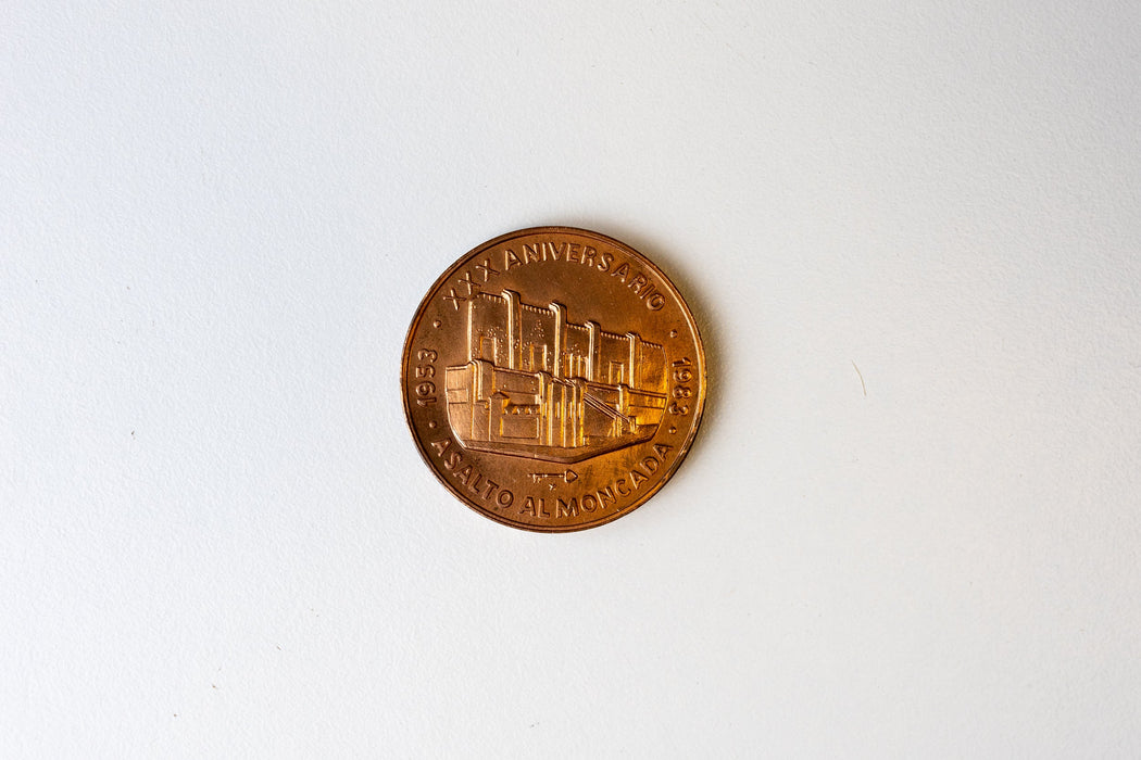 Two rare Cuban coins, one likely signed by Fidel Castro